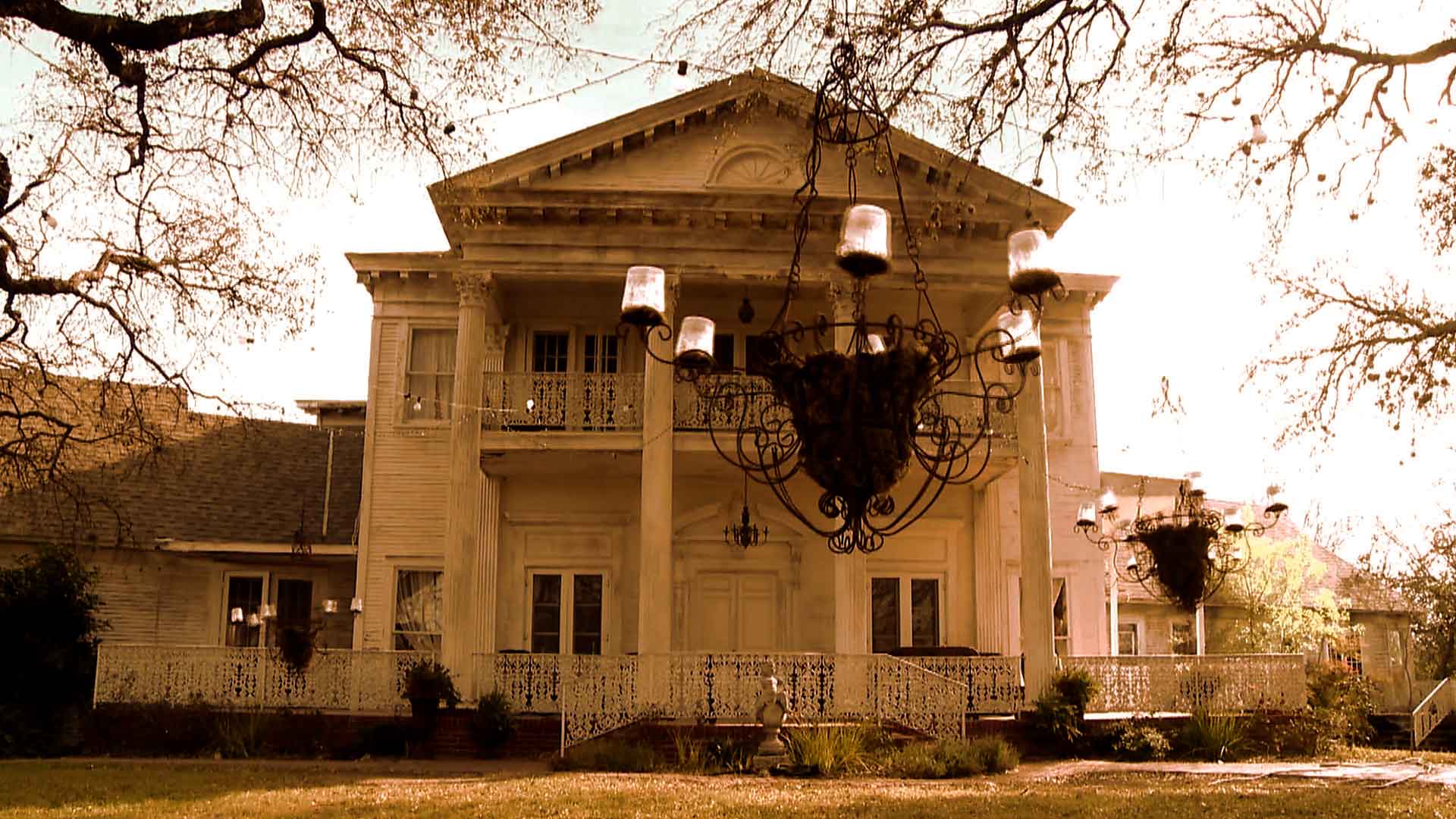 A large white building with a chandelier hanging from the ceiling.