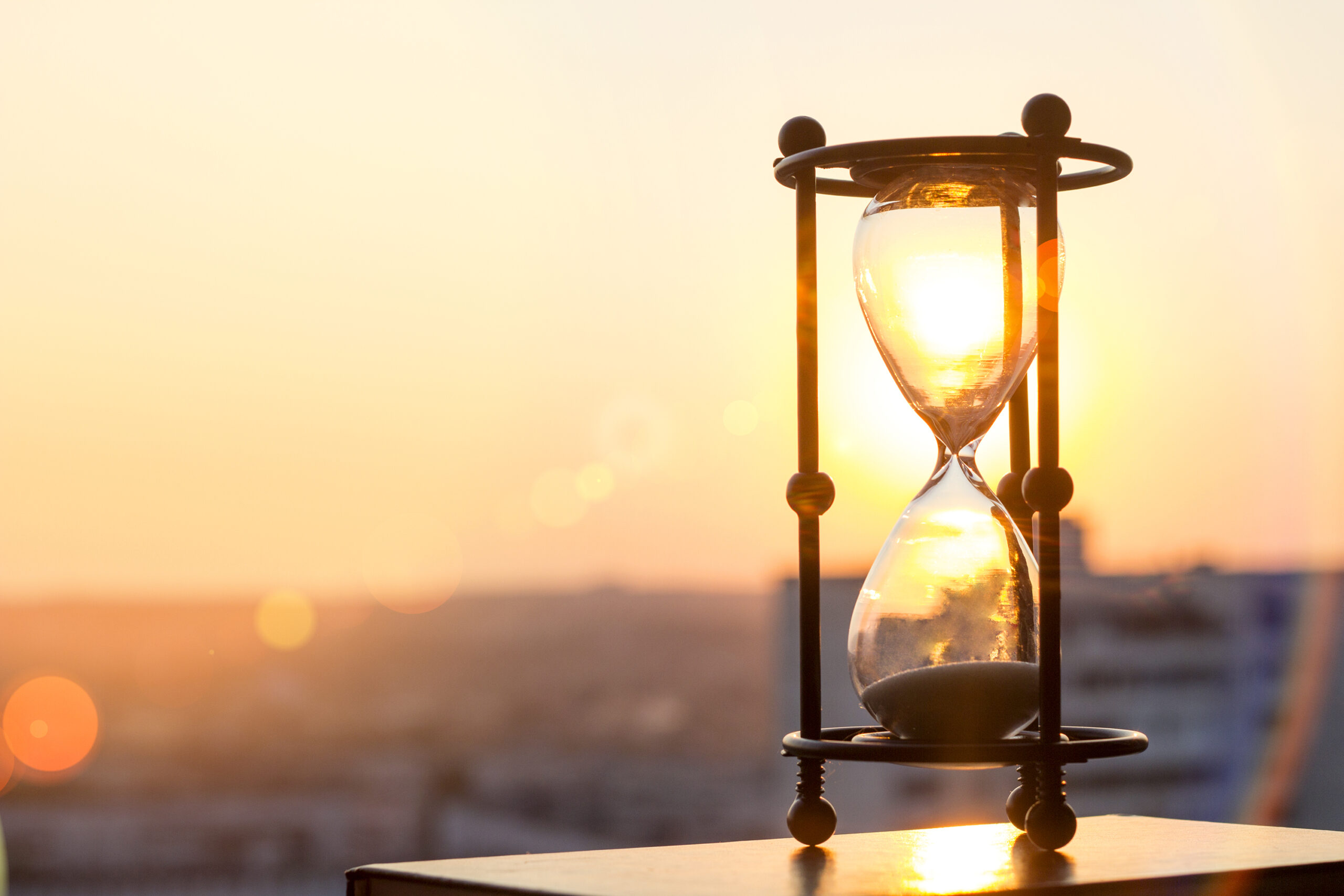 A close up of an hourglass on top of a table