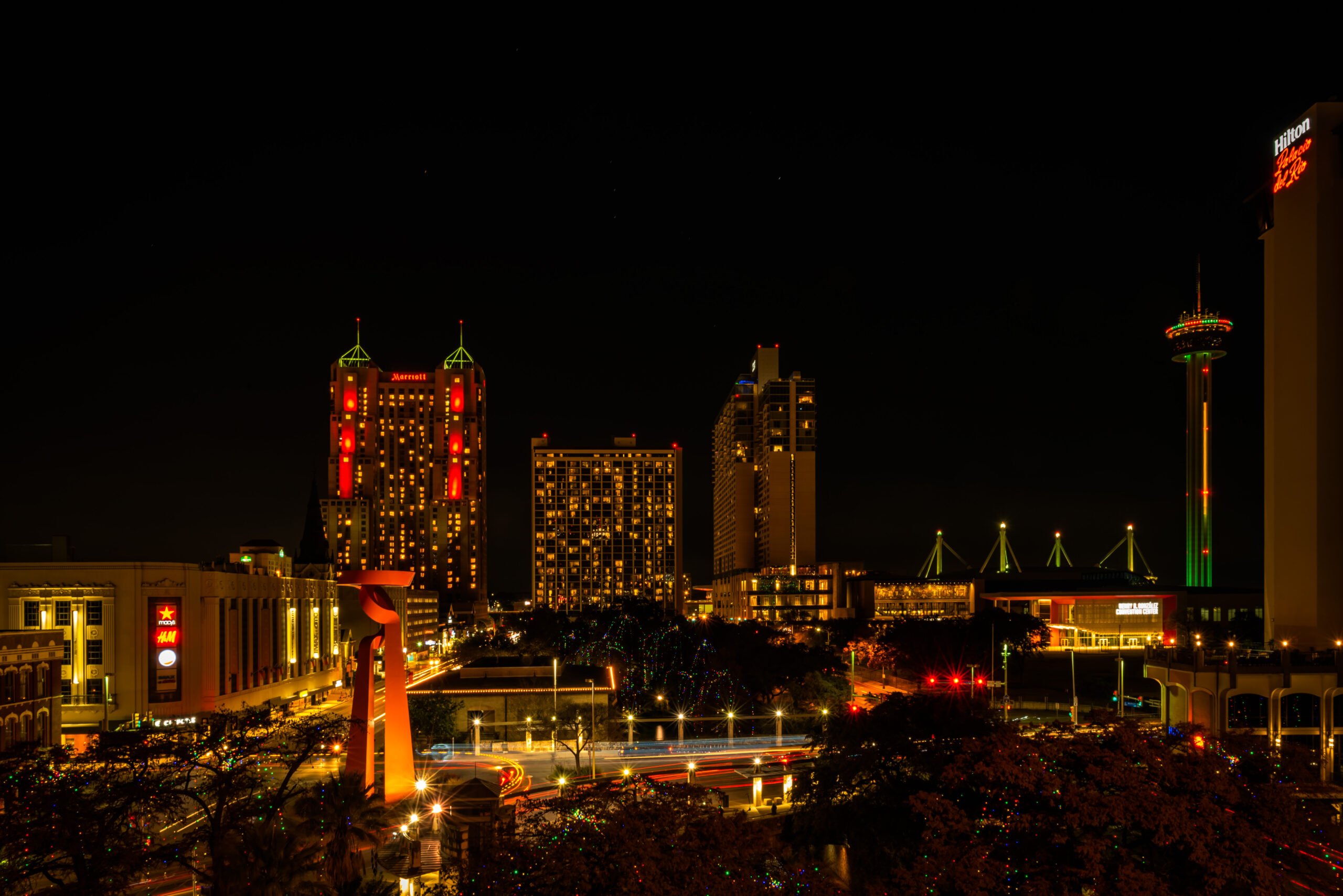 A city skyline at night with lights on.