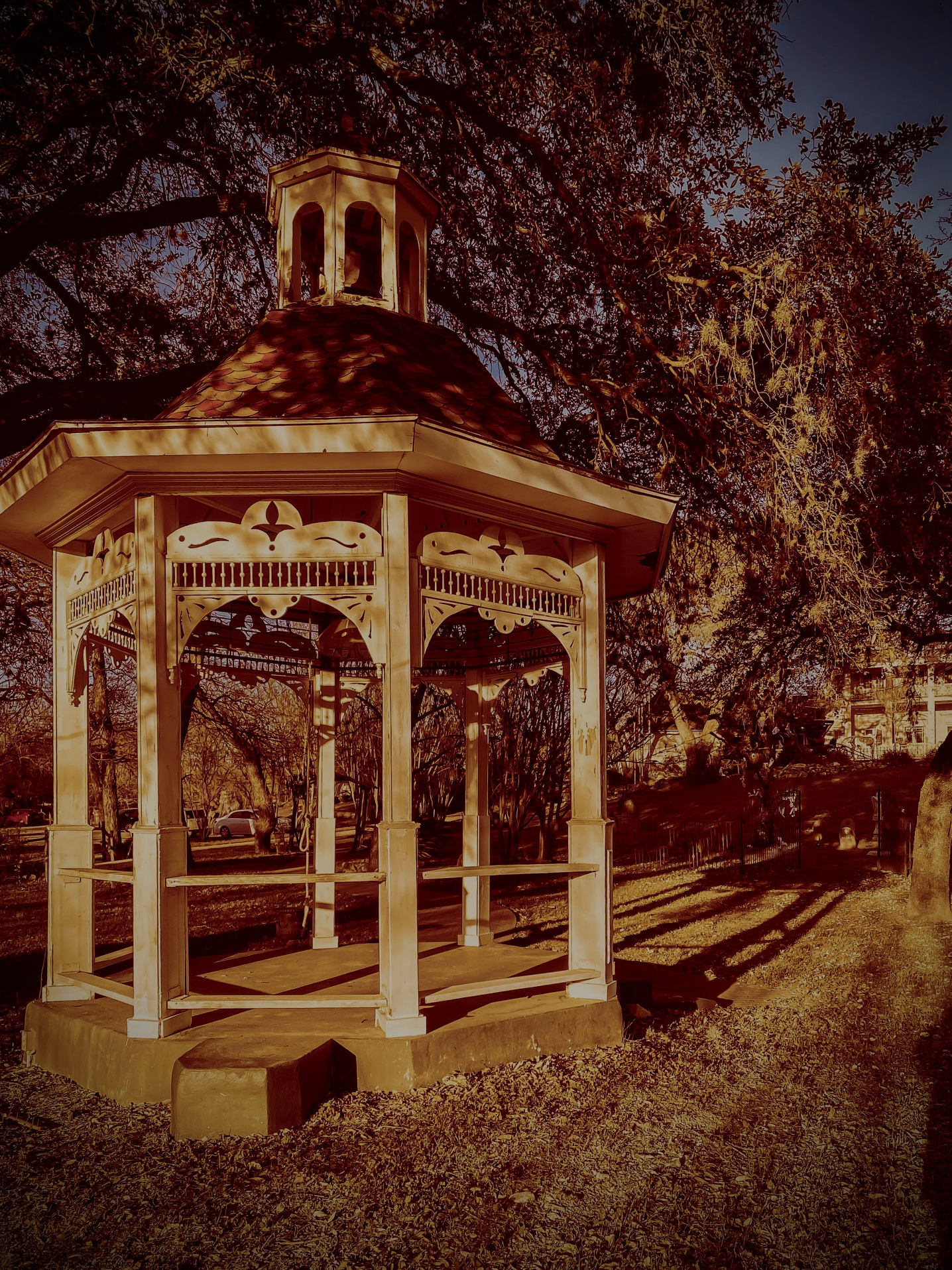 A gazebo with a clock on the top of it.