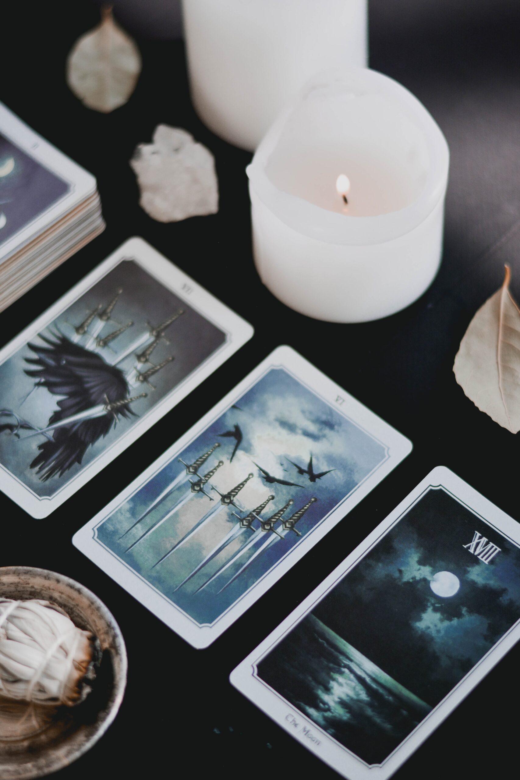 A table with tarot cards and candles on it.